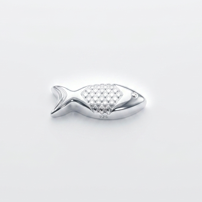 Silver fish-shaped object on a light gray background