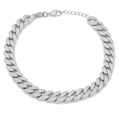 A bold 925 sterling silver Cuban link pet necklace entirely set with clear miniature round stones, shown against a plain light gray surface.