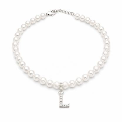A strand of uniform white pearls forming a pet necklace with a silver, stone-set letter 'L' monogram pendant in the center.