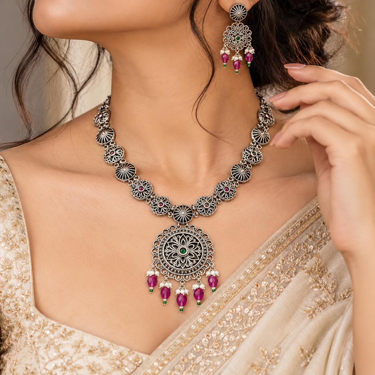 Vintage Silver Necklace Set featuring a deeply oxidized antique patina medallion with radial filigree, kundan-style stone arrangements, and matching drop earrings on a premium display stand by Rivansh.