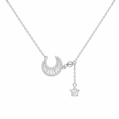 Asymmetric 925 sterling silver necklace featuring a pavé crescent moon and a dangling star drop charm.