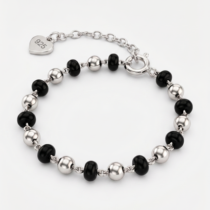Bracelet with black and silver beads on a white background