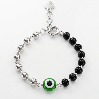 Bracelet with black beads and a green evil eye charm on a white background