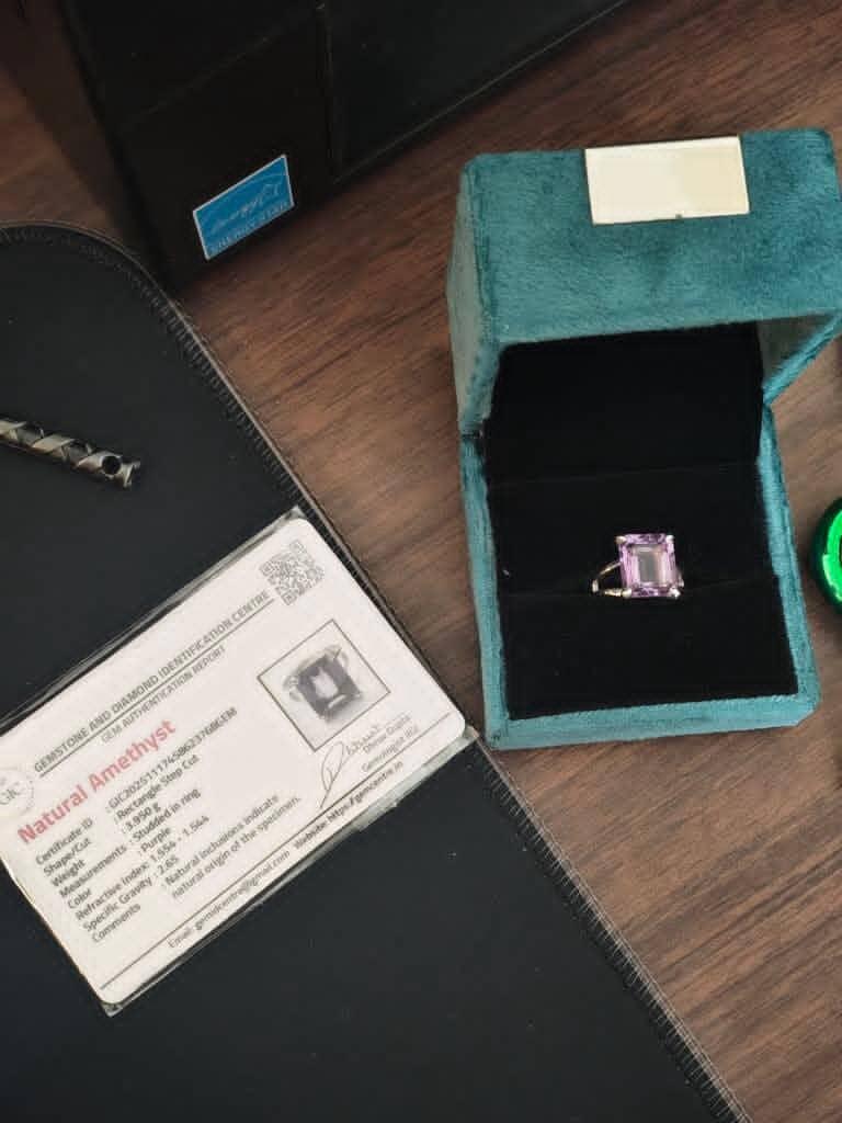 Custom Natural Amethyst Ring in BIS Hallmarked 925 Sterling Silver featuring a 3.950g emerald-cut solitaire stone with a minimalist split-shank design, shown beside its official laboratory certification card by Rivansh.