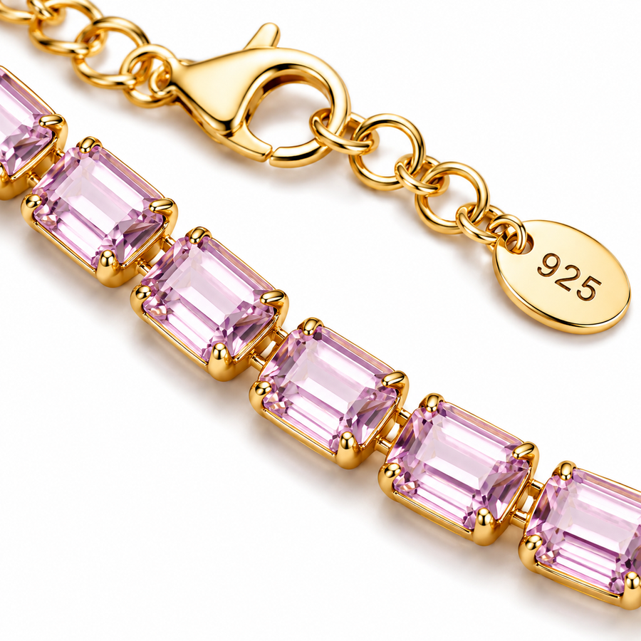 Gold Necklace with pink gemstones on a white background closeup angle