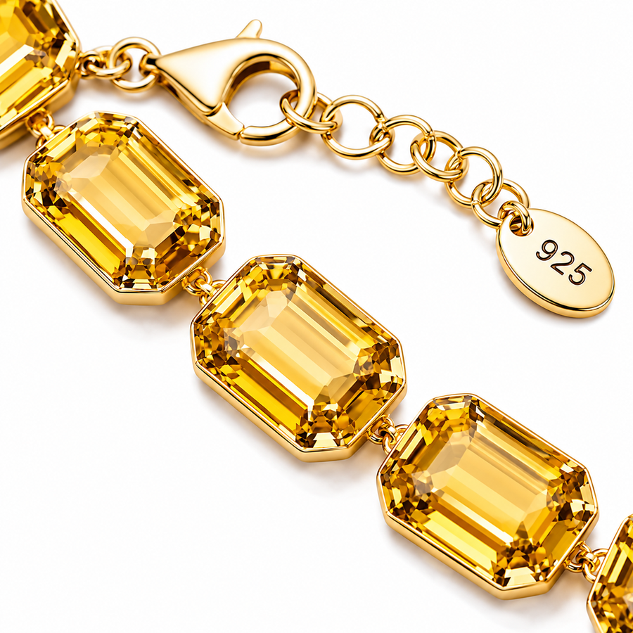 Gold bracelet with citrine stones and a '925' stamp on a white background