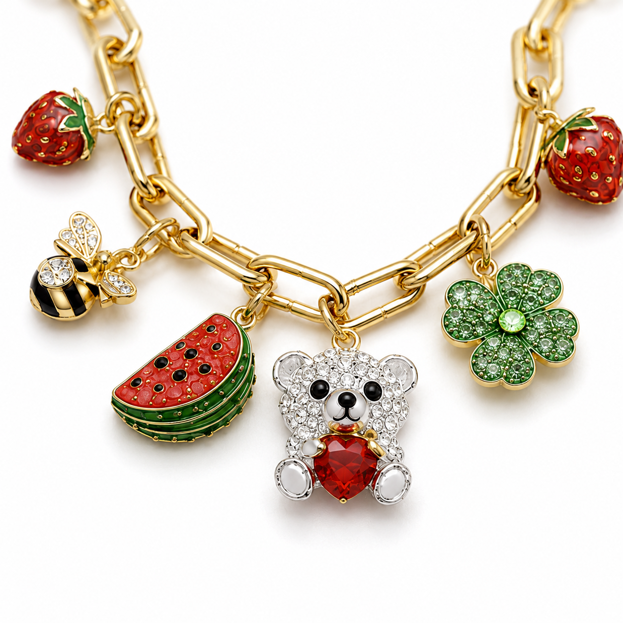Gold bracelet with colorful charms including a teddy bear, watermelon, strawberry, and flower on a white background.