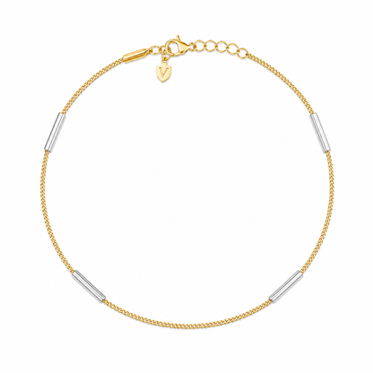 Gold bracelet with silver cylindrical beads on a white background