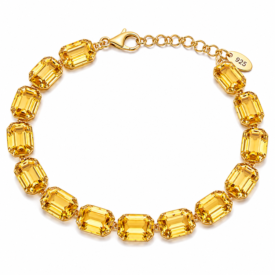 Gold bracelet with yellow gemstones on a white background