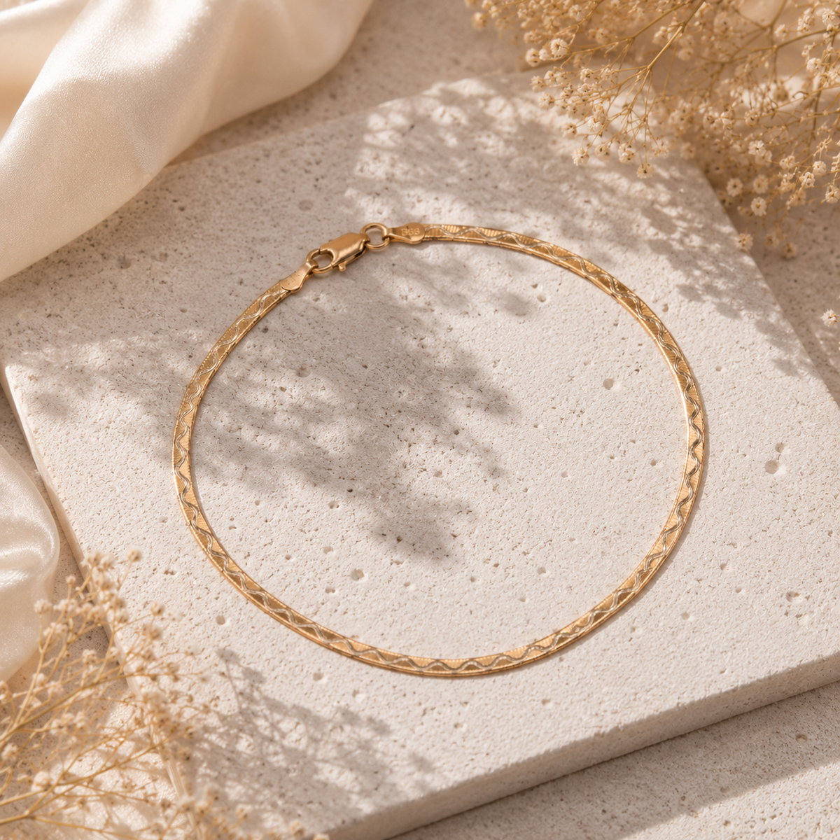 Luxurious 18K gold-plated 925 silver flat herringbone chain anklet with an etched wave pattern.