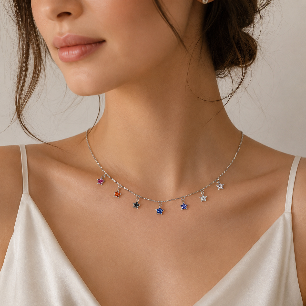 Necklace with colorful charms worn by a person against a neutral background