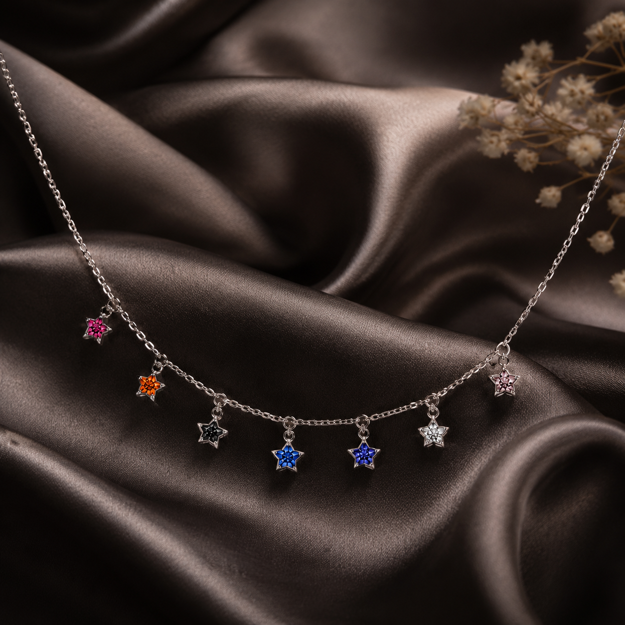 Necklace with star-shaped pendants on a dark fabric background