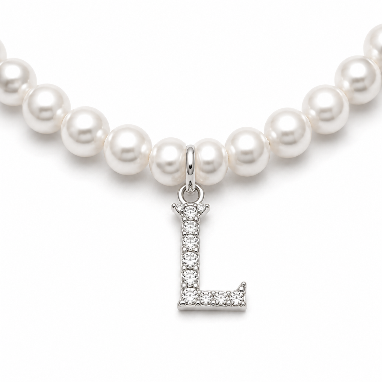 Pearl necklace with a silver 'L' charm on a white background