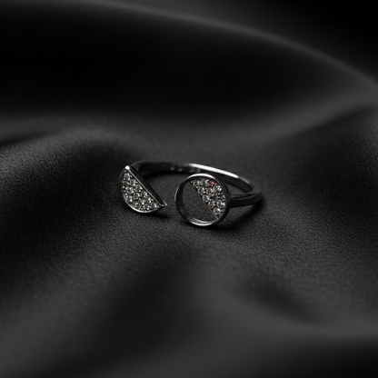 Rivansh asymmetric ring in 925 fine silver featuring a graduated multi-size stone row layout on black silk cloth background