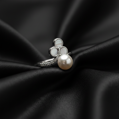 Rivansh minimal pearl ring featuring a single genuine freshwater pearl in a protective 925 silver bezel mount on black silk cloth