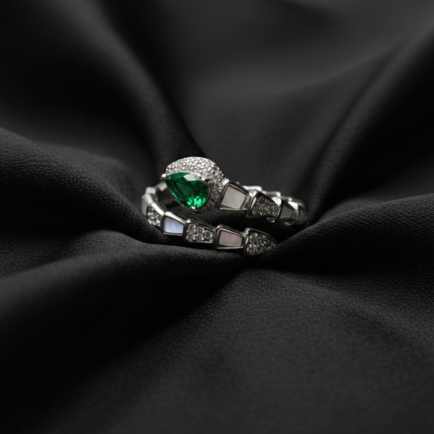 Rivansh water drop baguette solitaire ring in certified 925 silver with low-profile corner prongs on beautiful silk cloth background