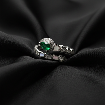 Rivansh water drop baguette solitaire ring in certified 925 silver with low-profile corner prongs on beautiful silk cloth background