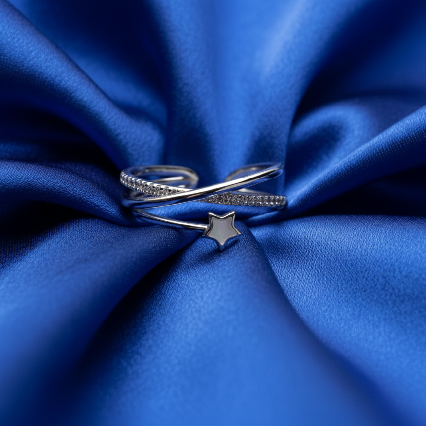 Rivansh wide flat statement band in 925 silver with a central starburst engraved diamond cut setting on silk cloth