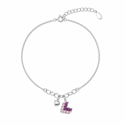 Silver anklet with a heart charm and pink gemstone on a white background