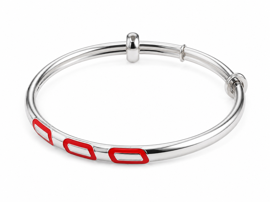 Silver bangle with red accents on a white background