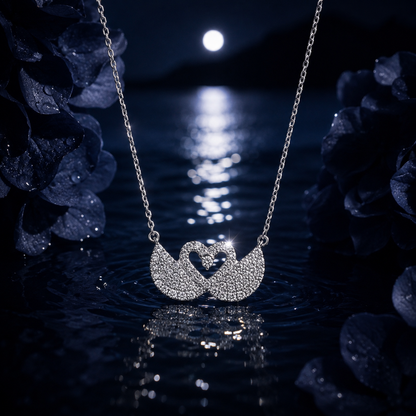 Silver necklace with a heart-shaped pendant on a reflective water surface at night.