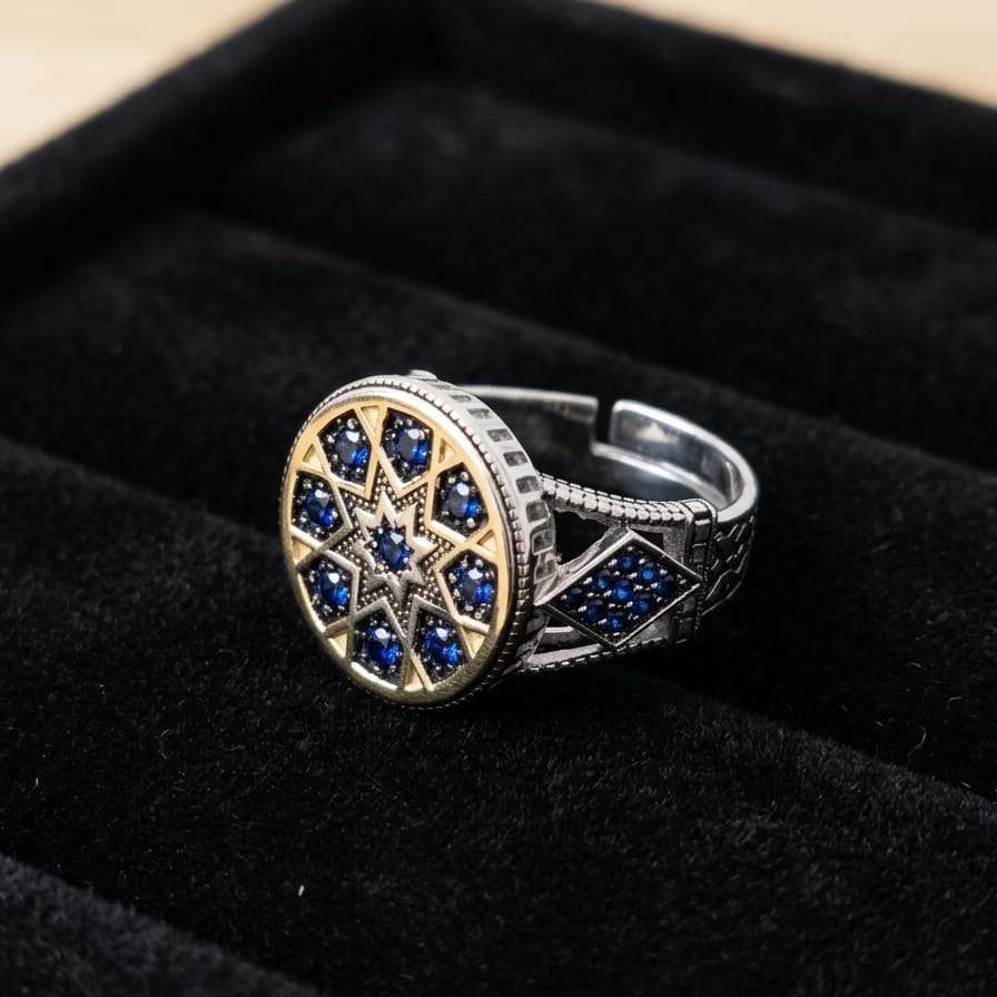 Silver ring with blue gemstones on a black velvet background