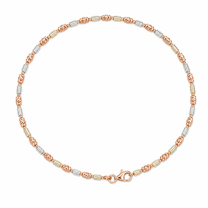 Two-tone gold anklet on a white background